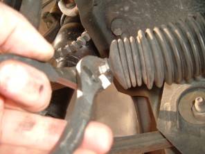 Pliers removing quick clamp on end of bellow.jpg